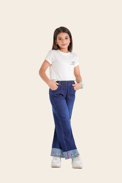 Young girl wearing a white t-shirt and blue jeans on a white background